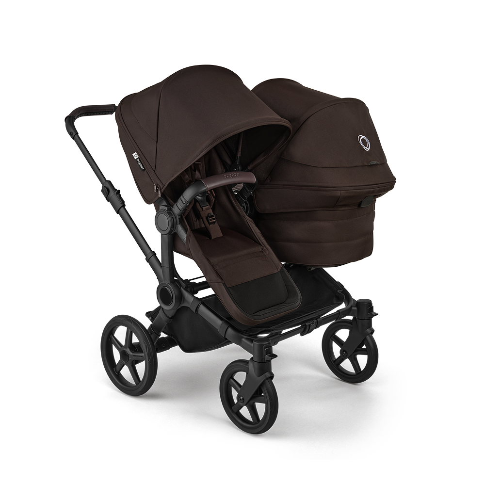 A Bugaboo Donkey 6 stroller in double configuration, featuring a seat and a bassinet. The fabrics are in Cocoa Brown.