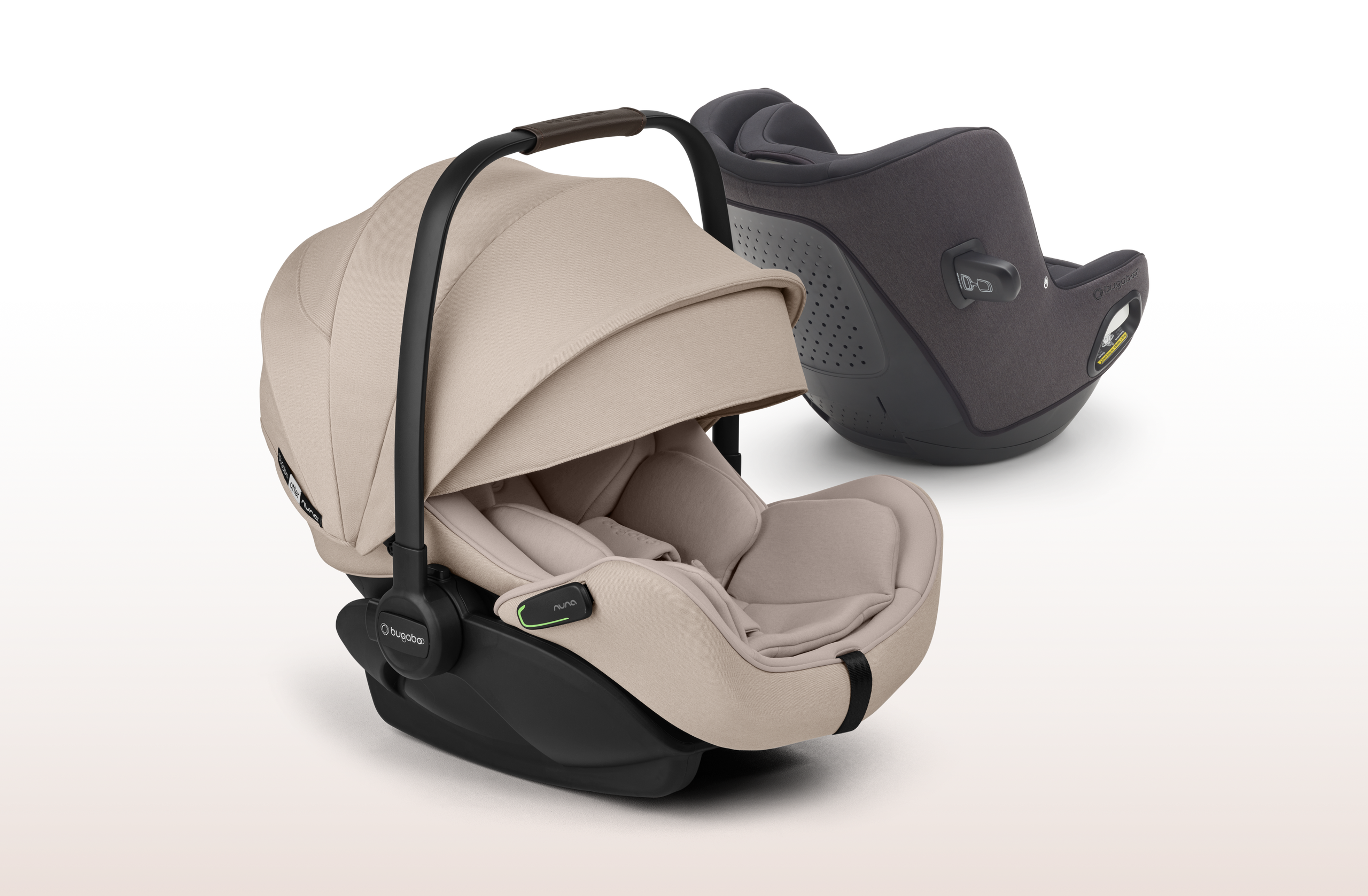Image de deux sièges auto Au premier plan, le siège auto pour bébé Bugaboo Otter by Nuna avec des tissus Desert Taupe. À l'arrière, se trouve le siège auto convertible Bugaboo Owl by Nuna avec des tissus noirs.