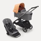 Bugaboo Dragonfly bassinet and seat stroller with graphite chassis, grey melange fabrics and island coral sun canopy.