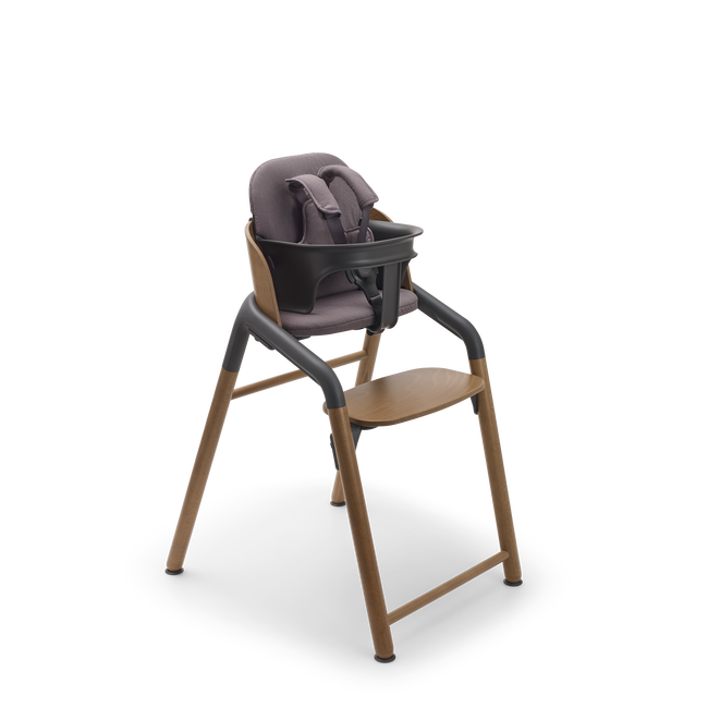 Bugaboo Giraffe chair in warm wood/grey, with baby set with harness and baby pillow set in grey.