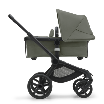 Side view of the Bugaboo Fox 5 bassinet stroller with black chassis, forest green fabrics and forest green sun canopy. - view 2