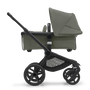 Side view of the Bugaboo Fox 5 bassinet stroller with black chassis, forest green fabrics and forest green sun canopy. - Thumbnail Slide 2 of 15