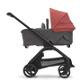 Side view of the Bugaboo Dragonfly bassinet stroller with black chassis, grey melange fabrics and sunrise red sun canopy. - Thumbnail Slide 4 of 18