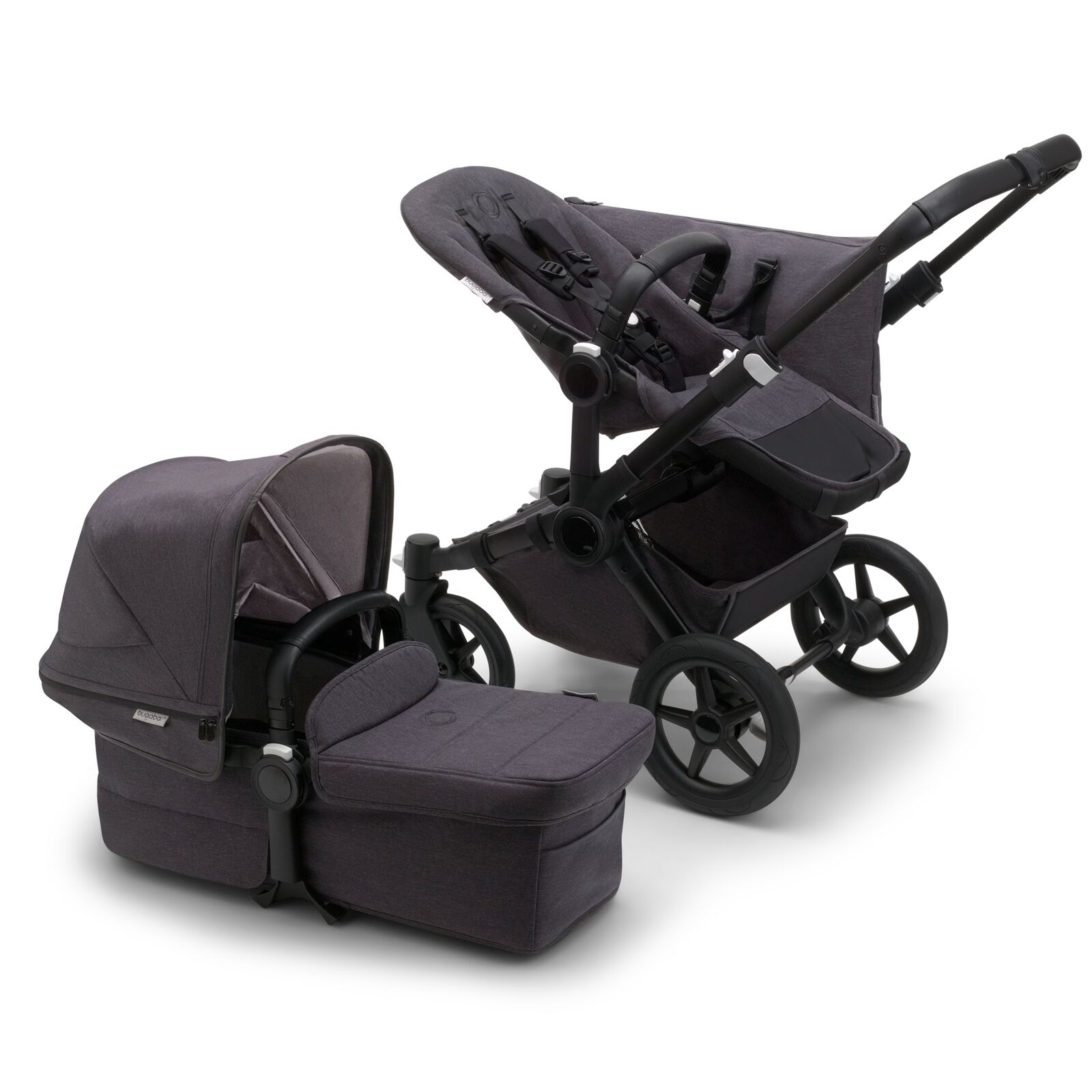 Bugaboo Donkey 5 Mono seat stroller with black chassis and mineral washed black fabrics, plus bassinet with mineral washed black sun canopy.