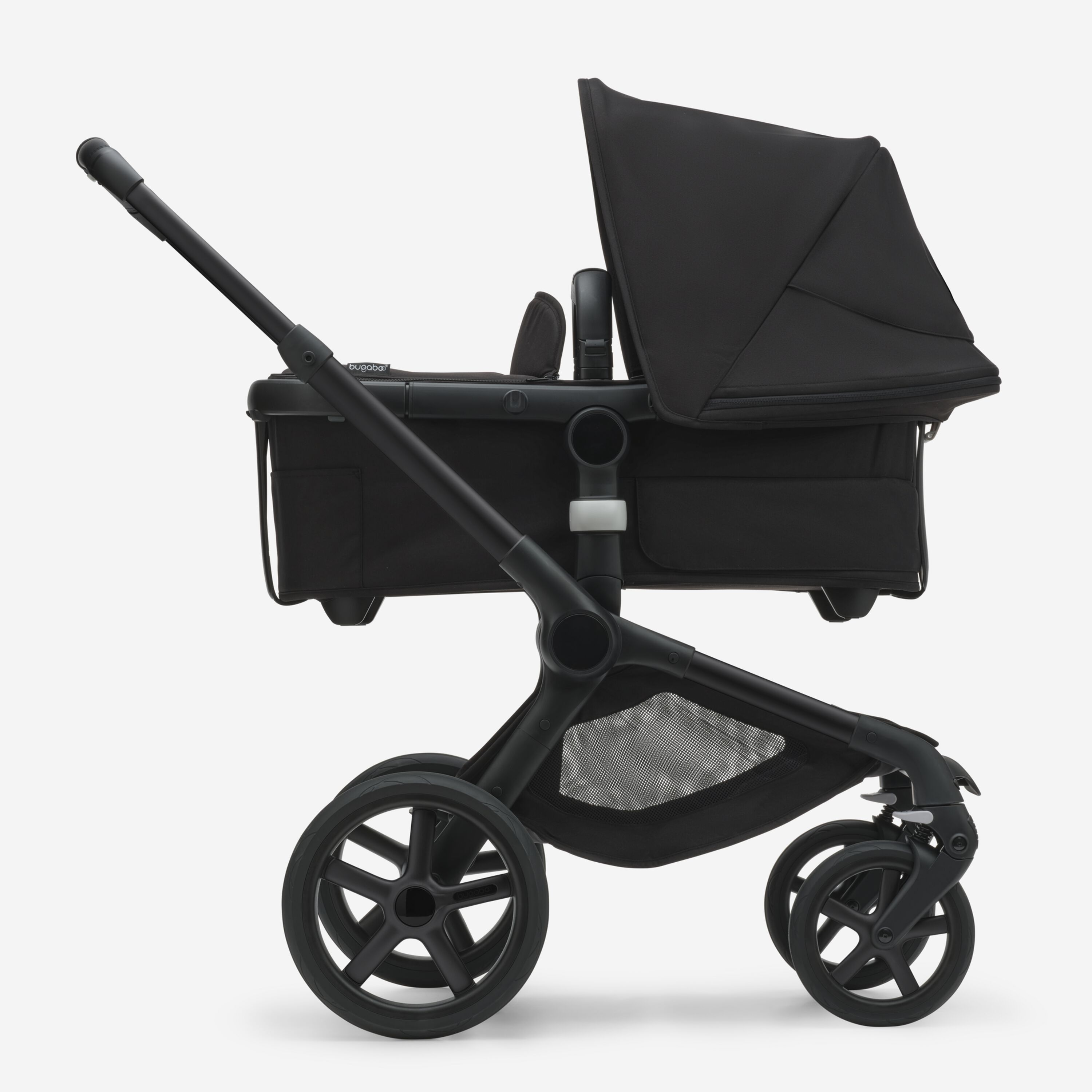 Side view of the Bugaboo Fox 5 bassinet pram with black chassis, forest green fabrics and forest green sun canopy. - Main Modal Image Slide 2 of 13
