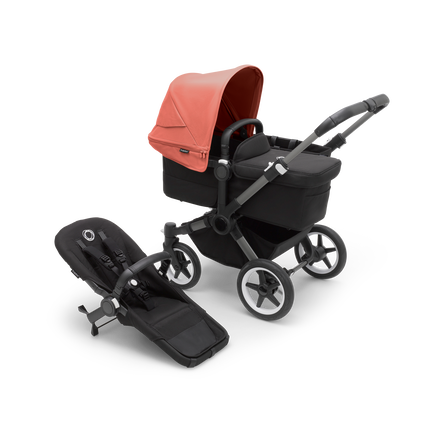 Bugaboo Donkey 5 Mono bassinet stroller with graphite chassis, midnight black fabrics and sunrise red sun canopy, plus seat.