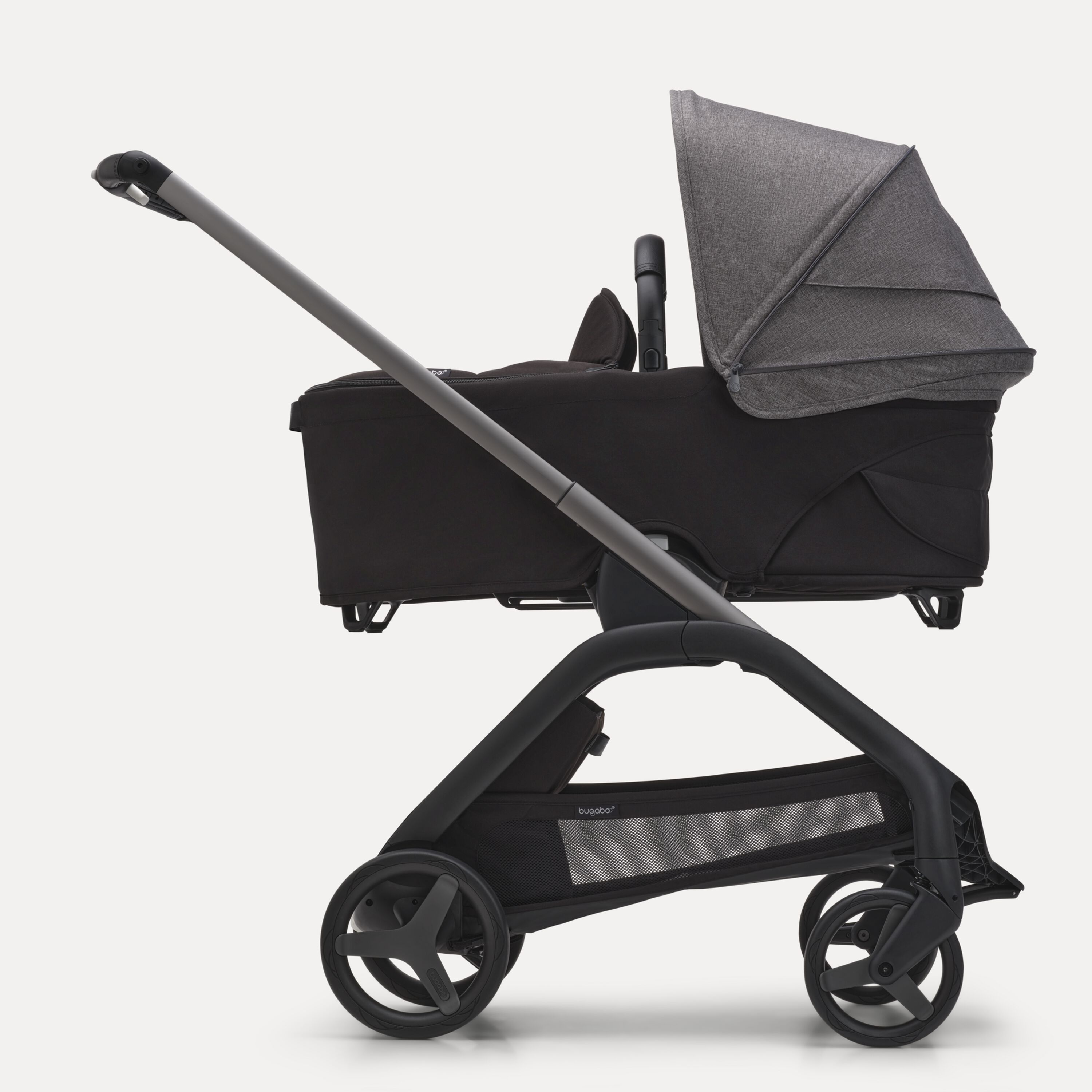 Side view of the Bugaboo Dragonfly bassinet stroller with graphite chassis, midnight black fabrics and grey melange sun canopy. - Main Modal Image Slide 3 of 16