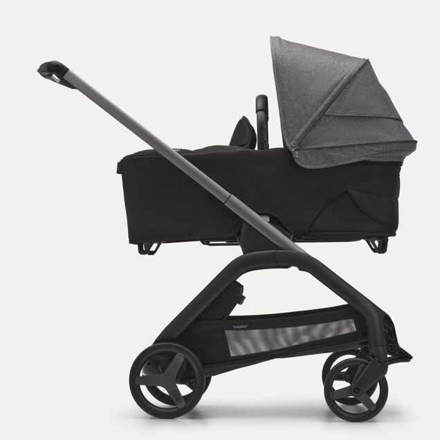 Side view of the Bugaboo Dragonfly bassinet stroller with graphite chassis, midnight black fabrics and grey melange sun canopy. - Main Image Slide 3 of 16