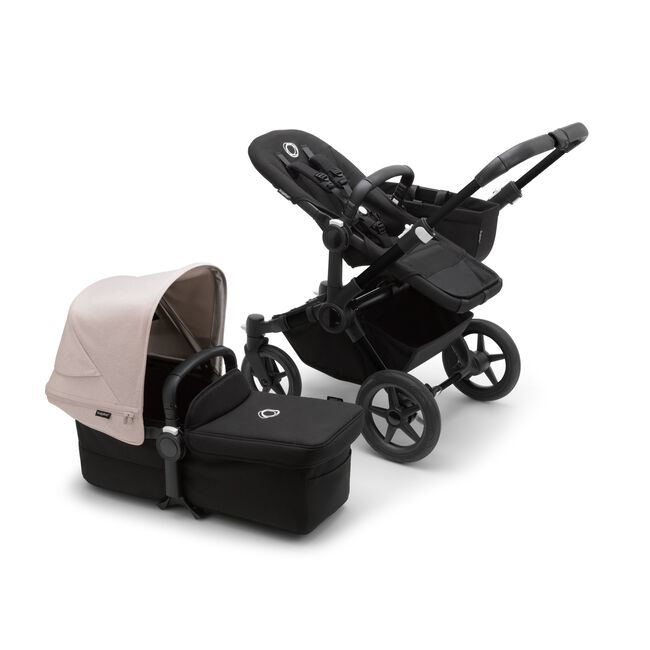 Bugaboo Donkey 5 Mono seat stroller with black chassis and midnight black fabrics, plus bassinet with misty white sun canopy.