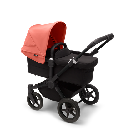Bugaboo Donkey 5 Mono bassinet stroller with black chassis, midnight black fabrics and sunrise red sun canopy.