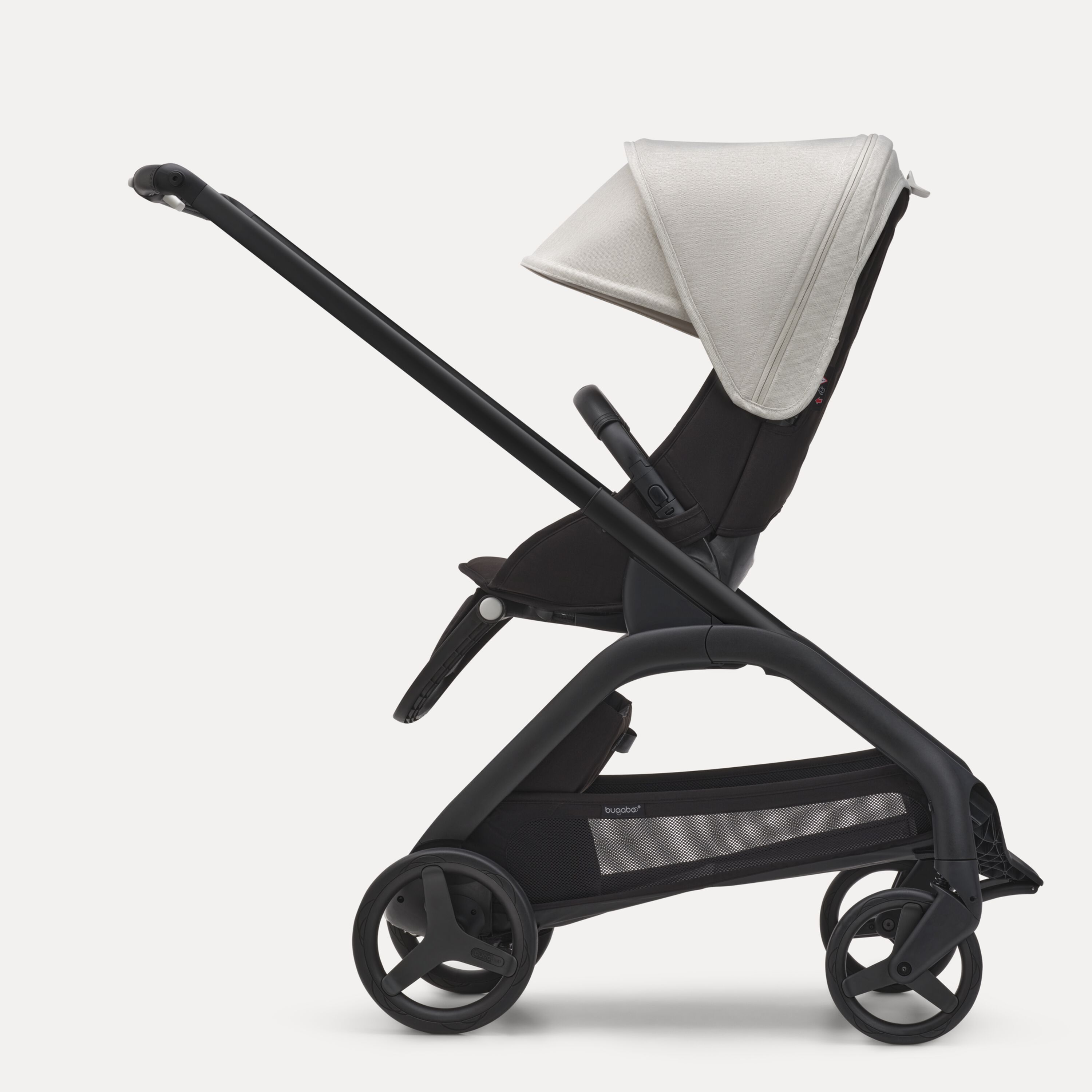Side view of the Bugaboo Dragonfly seat stroller with black chassis, midnight black fabrics and misty white sun canopy. - Main Modal Image Slide 2 of 16