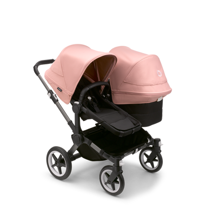 Bugaboo Donkey 5 Duo seat and bassinet stroller with graphite chassis, midnight black fabrics and morning pink sun canopy.