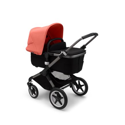 Bugaboo Fox 3 carrycot pushchair with graphite frame, black fabrics, and red sun canopy.