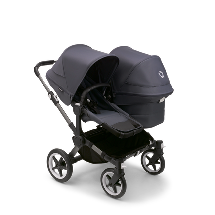 Bugaboo Donkey 5 Duo seat and bassinet stroller with graphite chassis, stormy blue fabrics and stormy blue sun canopy.