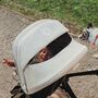 Smiling baby looking through the peekaboo panel of a white Bugaboo sun canopy. - Thumbnail Slide 4 of 7