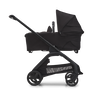Side view of the Bugaboo Dragonfly bassinet pram with black chassis, midnight black fabrics and midnight black sun canopy.