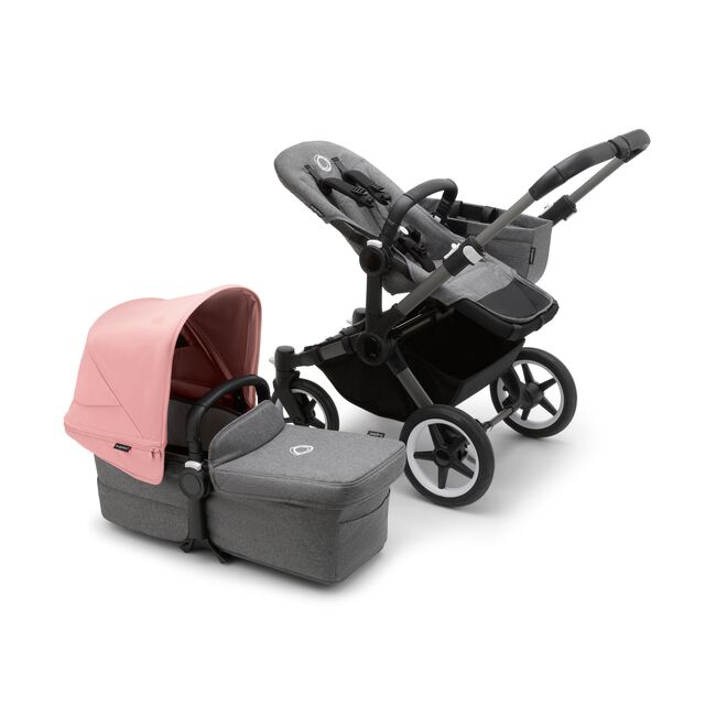 Bugaboo Donkey 5 Mono seat stroller with graphite chassis and grey melange fabrics, plus bassinet with morning pink sun canopy.