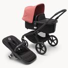 Poussette siège et nacelle Bugaboo Fox 5 avec châssis noir, habillages nuit noire et capote rouge sunrise.
