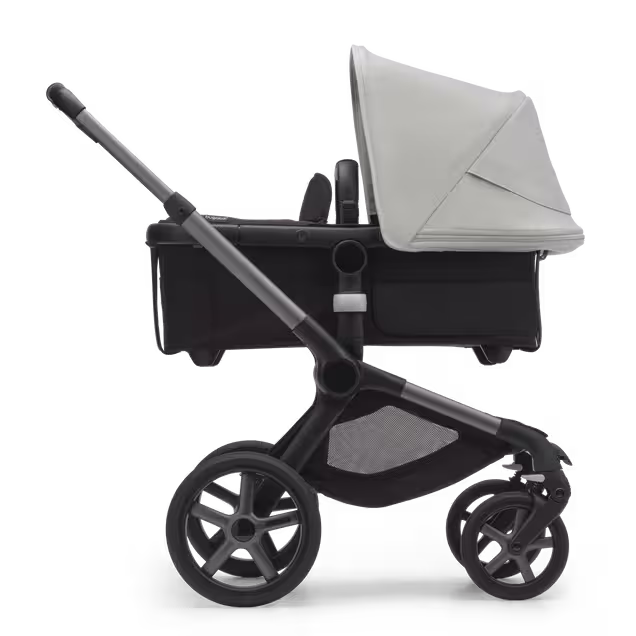 Side view of the Bugaboo Fox 5 carrycot pushchair with graphite chassis, midnight black fabrics and astro purple sun canopy. - Main Image Slide 2 of 13