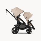 Bugaboo Kangaroo 2-in-1 tandem stroller with two seats, with Desert Taupe fabrics and Desert Taupe sun canopies.