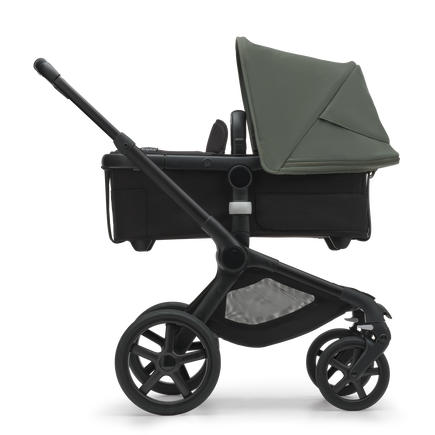 Side view of the Bugaboo Fox 5 bassinet stroller with black chassis, midnight black fabrics and forest green sun canopy. - view 2