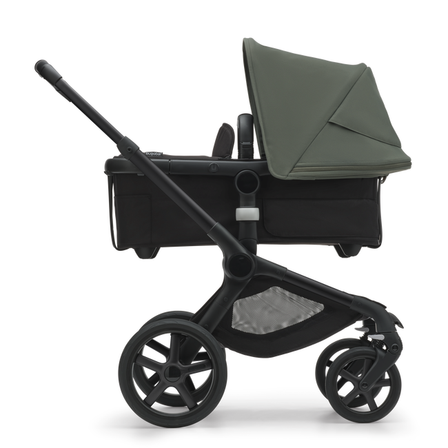 Side view of the Bugaboo Fox 5 bassinet stroller with black chassis, midnight black fabrics and forest green sun canopy.