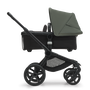 Side view of the Bugaboo Fox 5 bassinet stroller with black chassis, midnight black fabrics and forest green sun canopy. - Thumbnail Slide 3 of 15