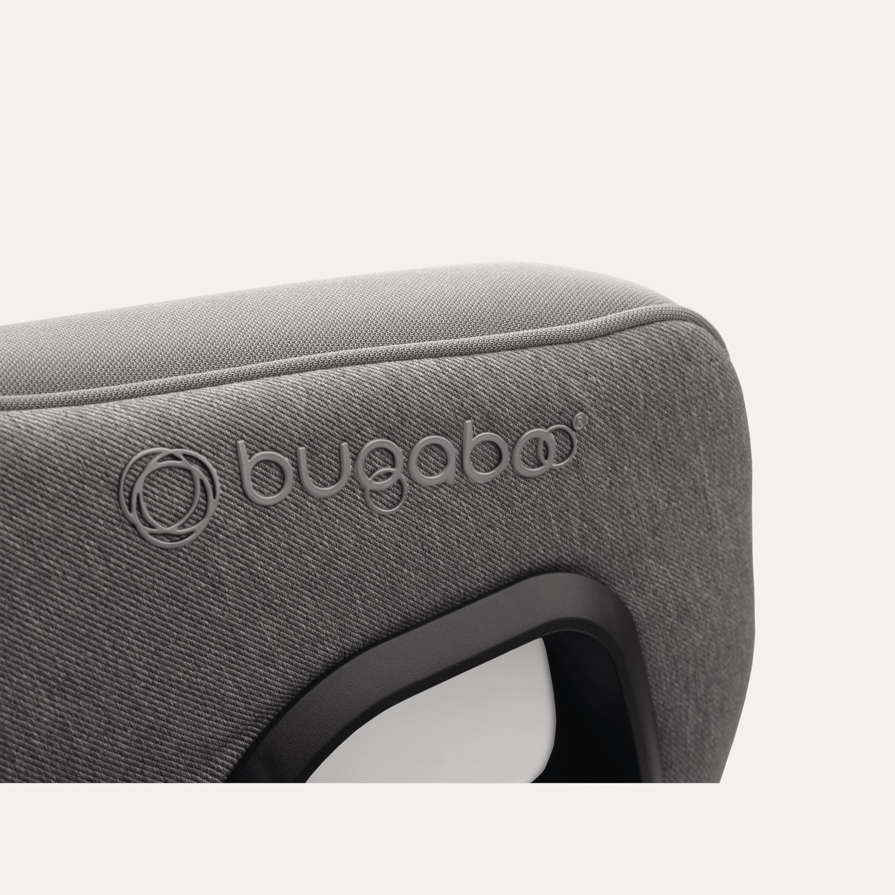 Close up of the embossed Bugaboo logo on the Bugaboo Owl by Nuna car seat in grey fabrics. - Main Modal Image Slide 11 of 13