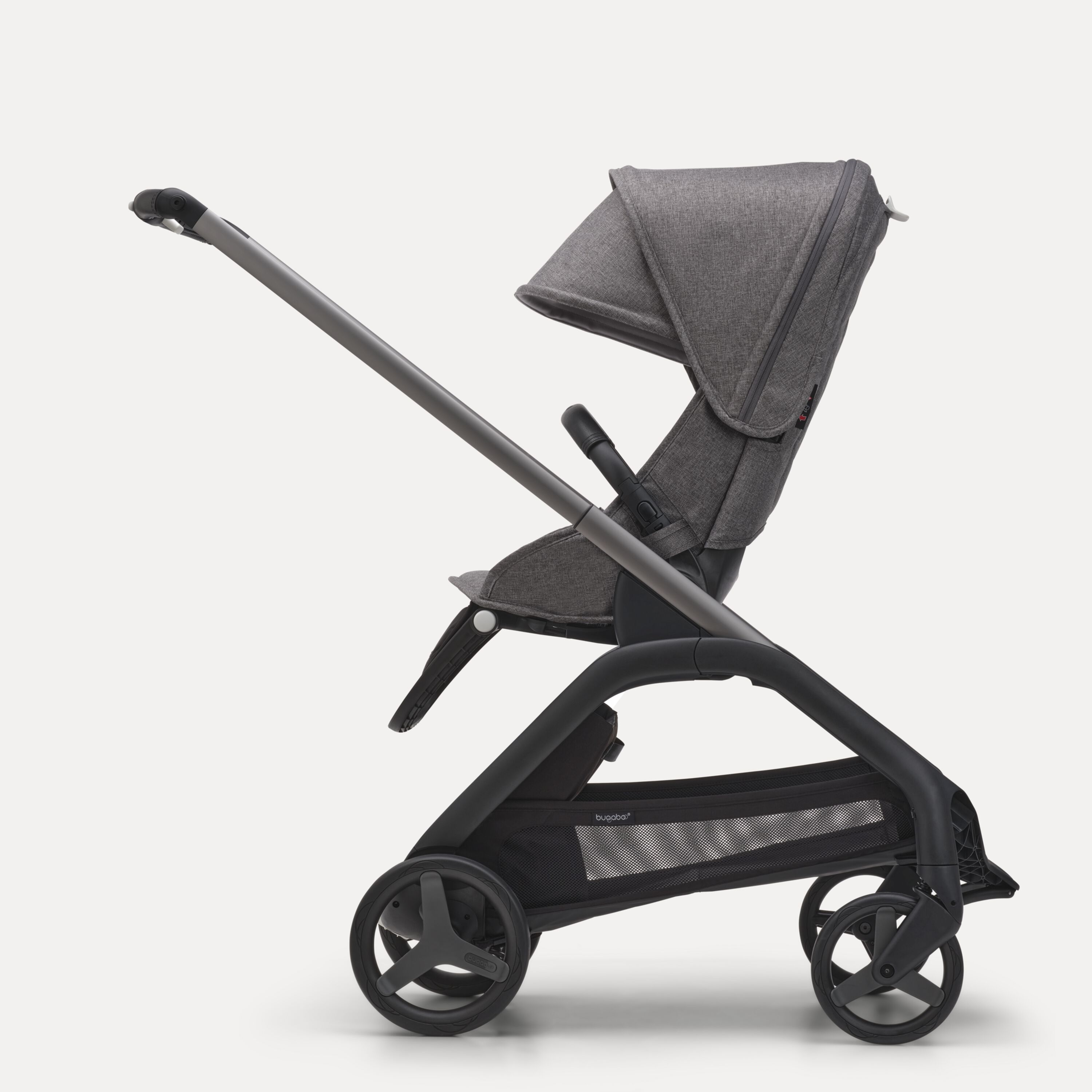Side view of the Bugaboo Dragonfly seat stroller with graphite chassis, grey melange fabrics and grey melange sun canopy. - Main Modal Image Slide 2 of 16