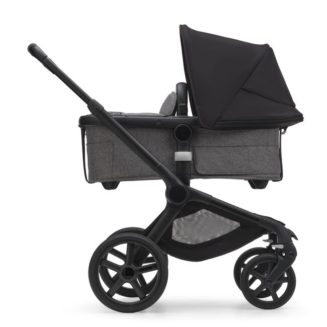 Side view of the Bugaboo Fox 5 bassinet pram with black chassis, forest green fabrics and forest green sun canopy. - Main Image Slide 3 of 13