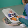 Baby in a Bugaboo rocker, with newborn set in white fabrics. - Thumbnail Slide 2 of 7