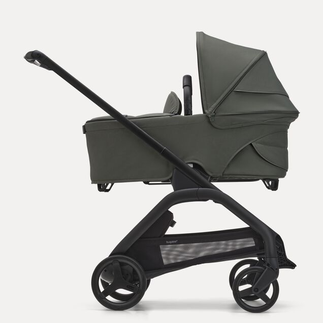 Side view of the Bugaboo Dragonfly bassinet stroller with black chassis, forest green fabrics and forest green sun canopy. - Main Image Slide 3 of 16