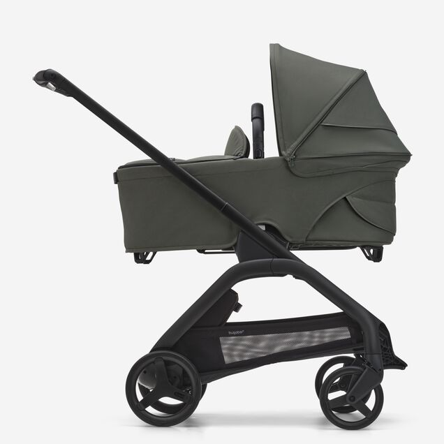 Side view of the Bugaboo Dragonfly bassinet stroller with black chassis, forest green fabrics and forest green sun canopy. - Main Image Slide 3 of 16