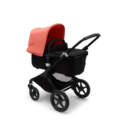 Bugaboo Fox 3 bassinet stroller with black frame, black fabrics, and red sun canopy.