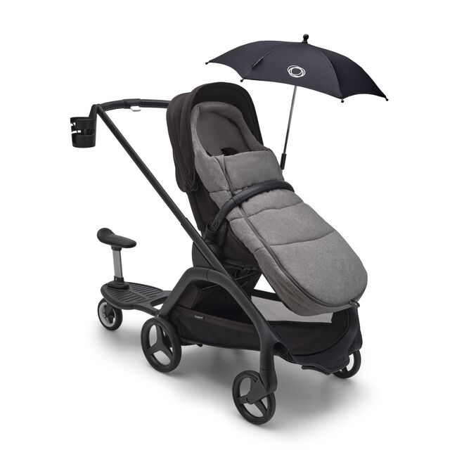 Bugaboo Dragonfly stroller with various accessories: sun canopy, footmuff, cup holder and comfort wheeled board.