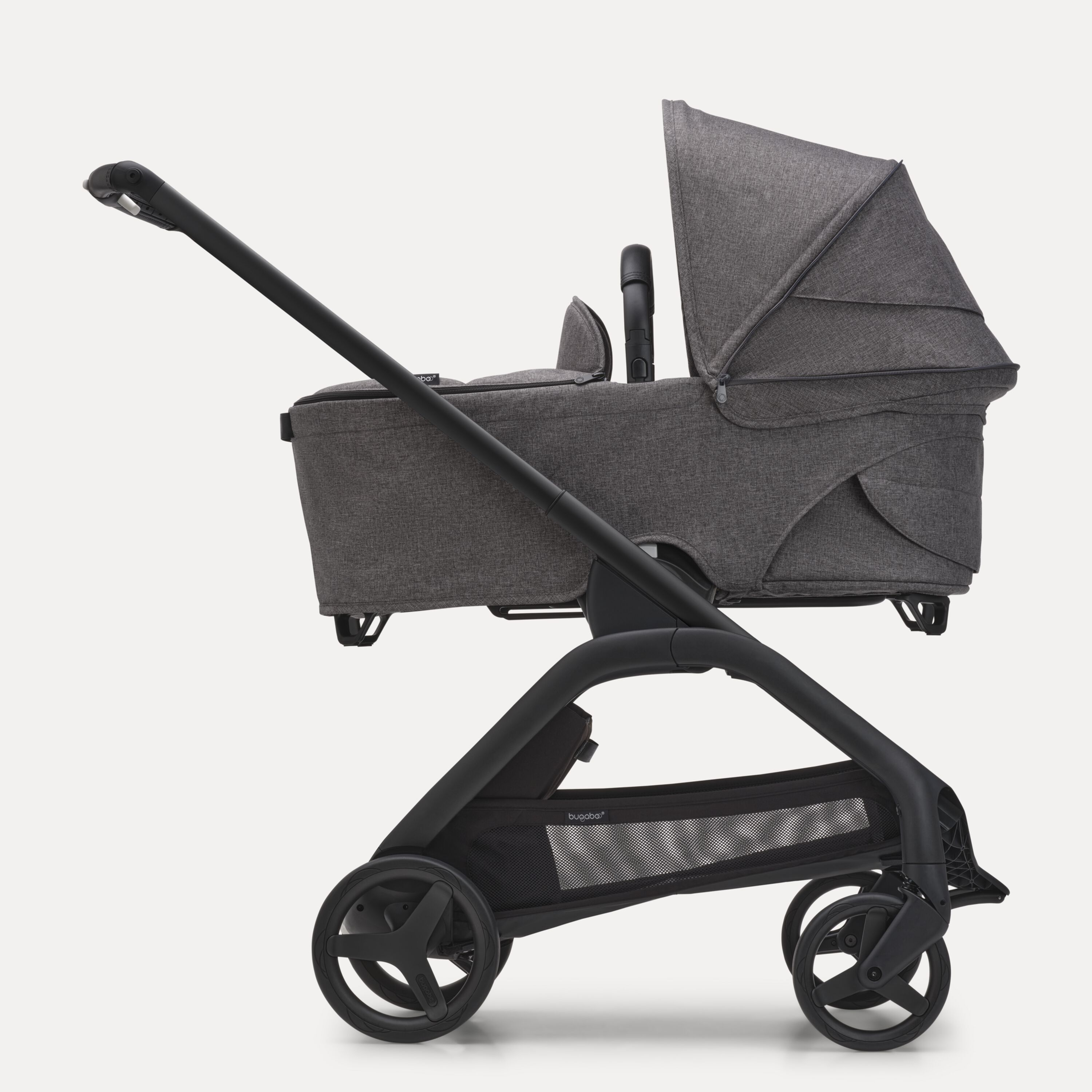 Side view of the Bugaboo Dragonfly bassinet stroller with black chassis, grey melange fabrics and grey melange sun canopy. - Main Modal Image Slide 3 of 16