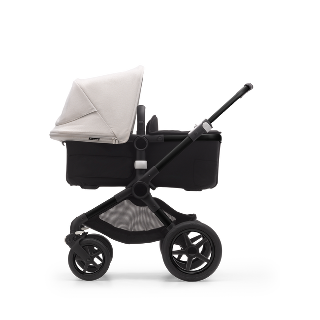Side view of a Bugaboo Fox 3 bassinet stroller with black frame, black fabrics, and white sun canopy.