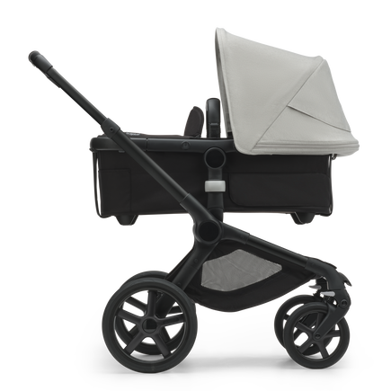 Side view of the Bugaboo Fox 5 bassinet stroller with black chassis, midnight black fabrics and misty white sun canopy. - view 2