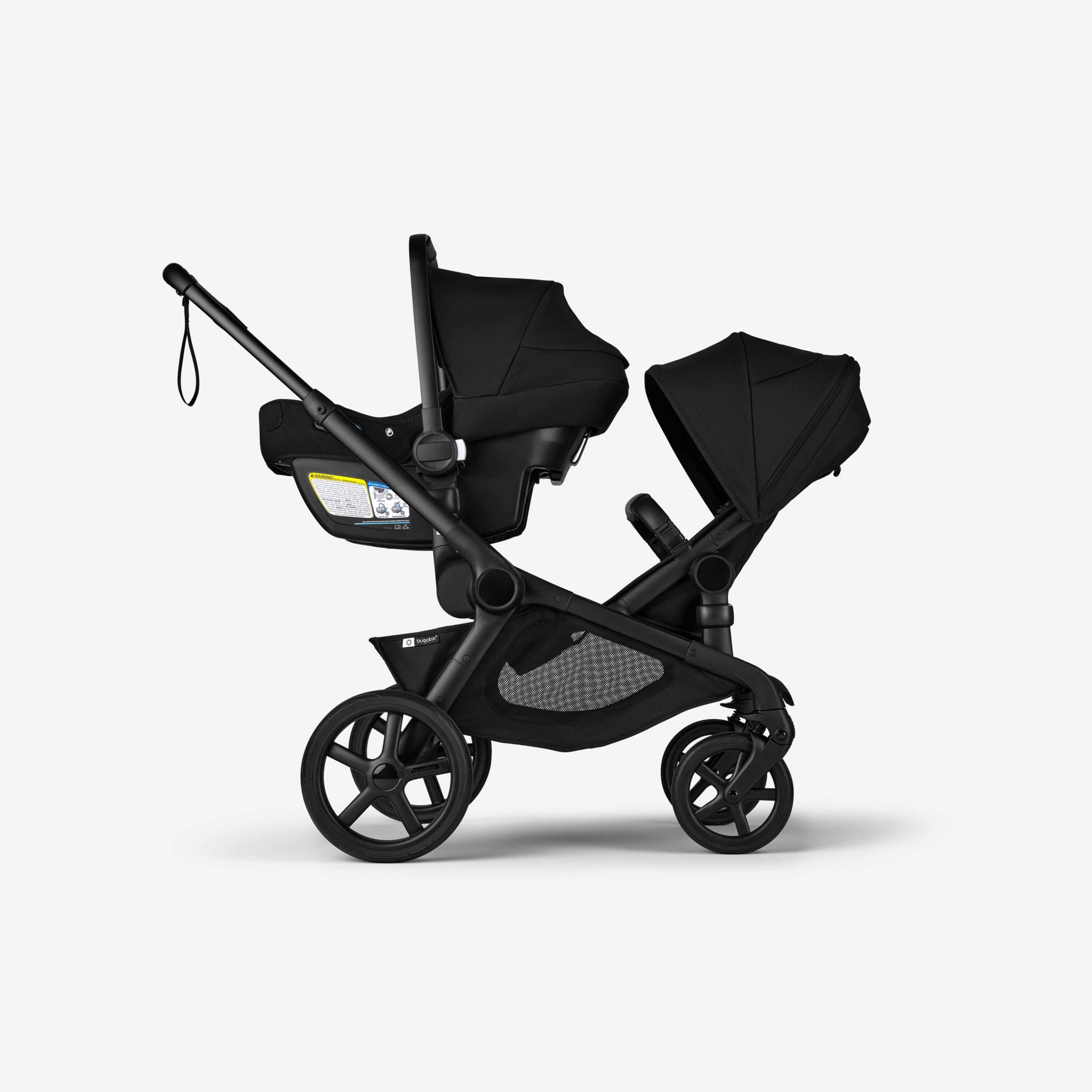 Bugaboo Kangaroo 2-in-1 tandem stroller with one car seat above and one bassinet below, with Midnight Black fabrics and Midnight Black sun canopies. - Main Modal Image Slide 16 of 18