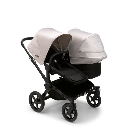 Bugaboo Donkey 5 Duo seat and bassinet stroller with black chassis, midnight black fabrics and misty white sun canopy.