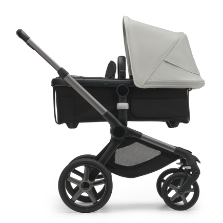 Side view of the Bugaboo Fox 5 bassinet stroller with graphite chassis, midnight black fabrics and misty white sun canopy. - view 2