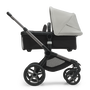 Side view of the Bugaboo Fox 5 bassinet stroller with graphite chassis, midnight black fabrics and misty white sun canopy. - Thumbnail Slide 3 of 15
