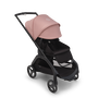 Bugaboo Dragonfly seat stroller with black chassis, midnight black fabrics and morning pink sun canopy. The sun canopy is fully extended.
