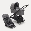 Bugaboo Dragonfly bassinet and seat stroller with black chassis, grey melange fabrics and grey melange sun canopy.