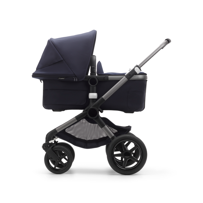 Side view of a Fox 3 bassinet stroller with graphite frame, dark navy fabrics, and dark navy sun canopy.
