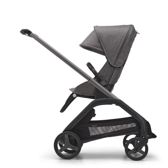 Side view of the Bugaboo Dragonfly seat pram with graphite chassis, grey melange fabrics and grey melange sun canopy.