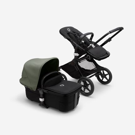 Bugaboo Fox 3 bassinet and seat stroller with black frame, black fabrics, and forest green sun canopy.