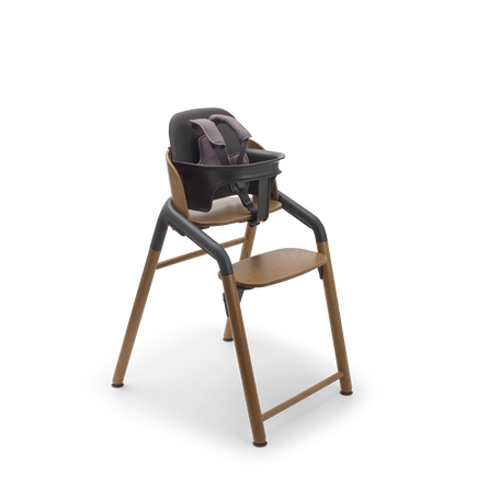Bugaboo Giraffe chair in warm wood/grey, with baby set and harness in grey.