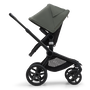 Side view of the Bugaboo Fox 5 seat stroller with black chassis, midnight black fabrics and forest green sun canopy. - Thumbnail Slide 4 of 16