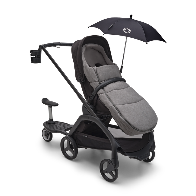 Bugaboo Dragonfly stroller with various accessories: sun canopy, footmuff, cup holder and comfort wheeled board.